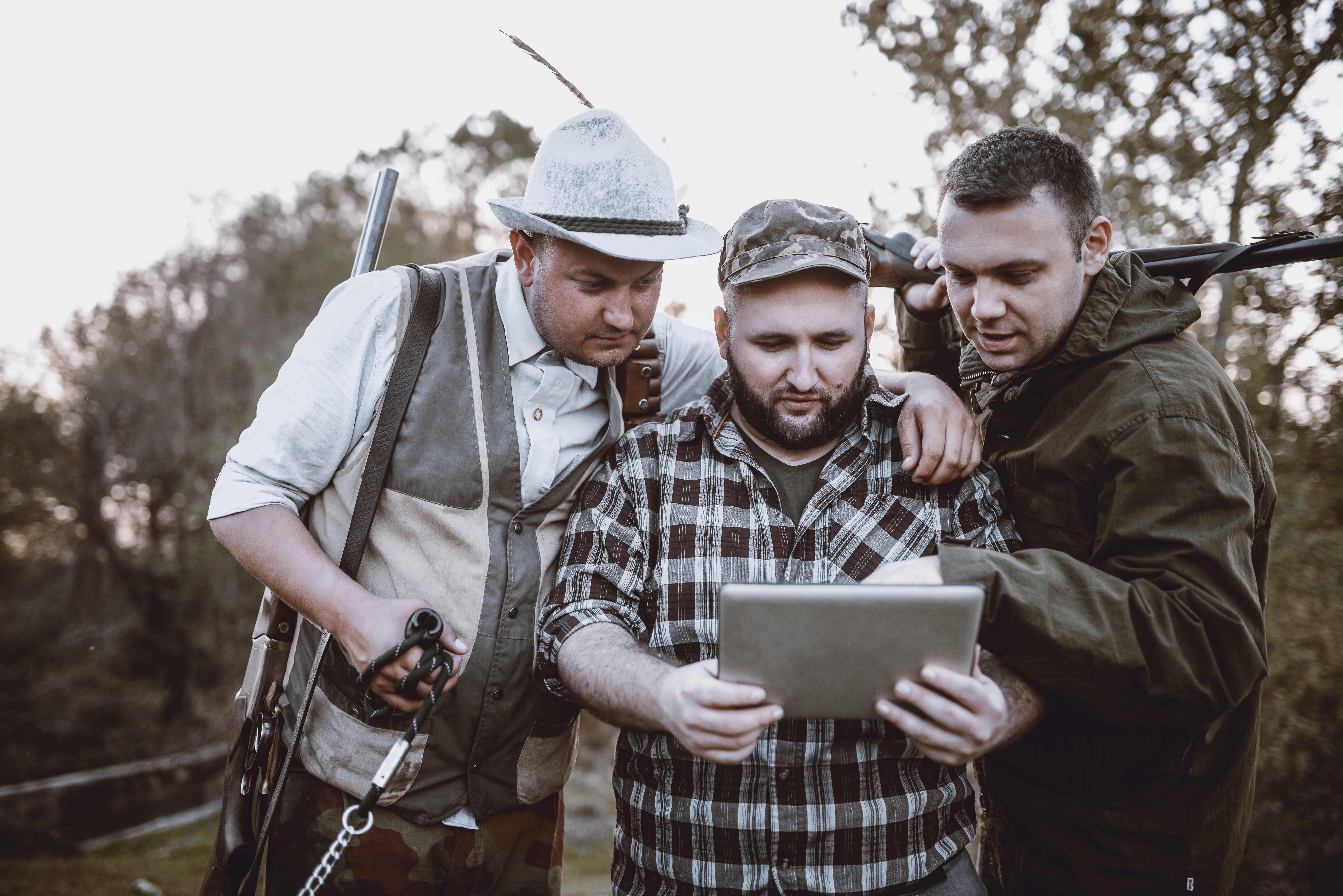 Group of hunters sharing a tablet